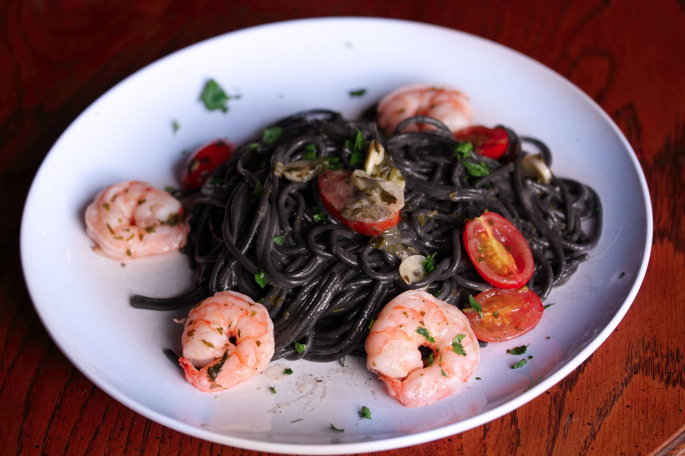 ink pasta with shrimps, tomatoes and garlic